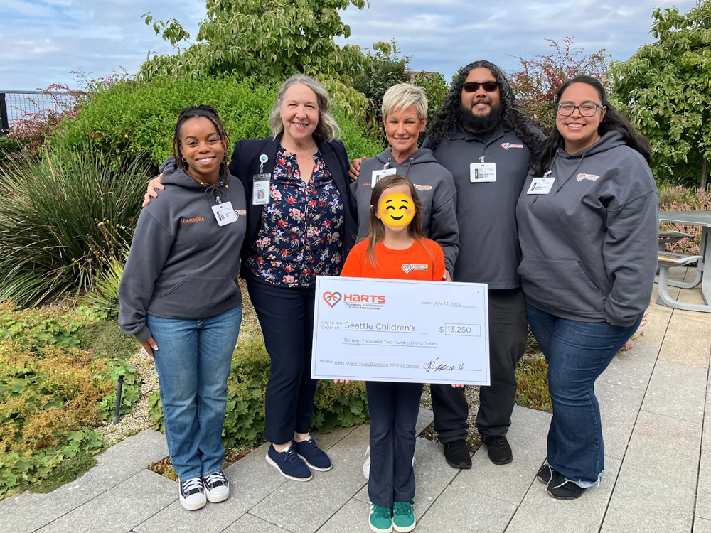Harts team members present a $13,250 check to the Seattle Children's Hospital on 7/23/25