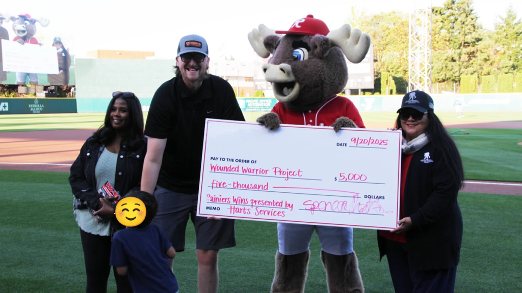 Harts presents a $5,000 check for the Wounded Warrior Project at the Tacoma Rainier's game on 9/20/25