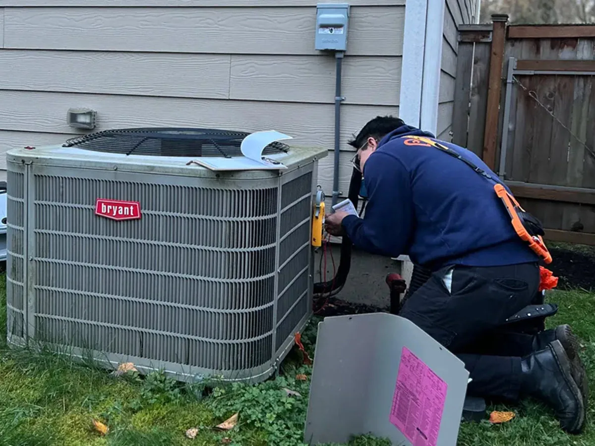 Harts HVAC technician checking AC system performance