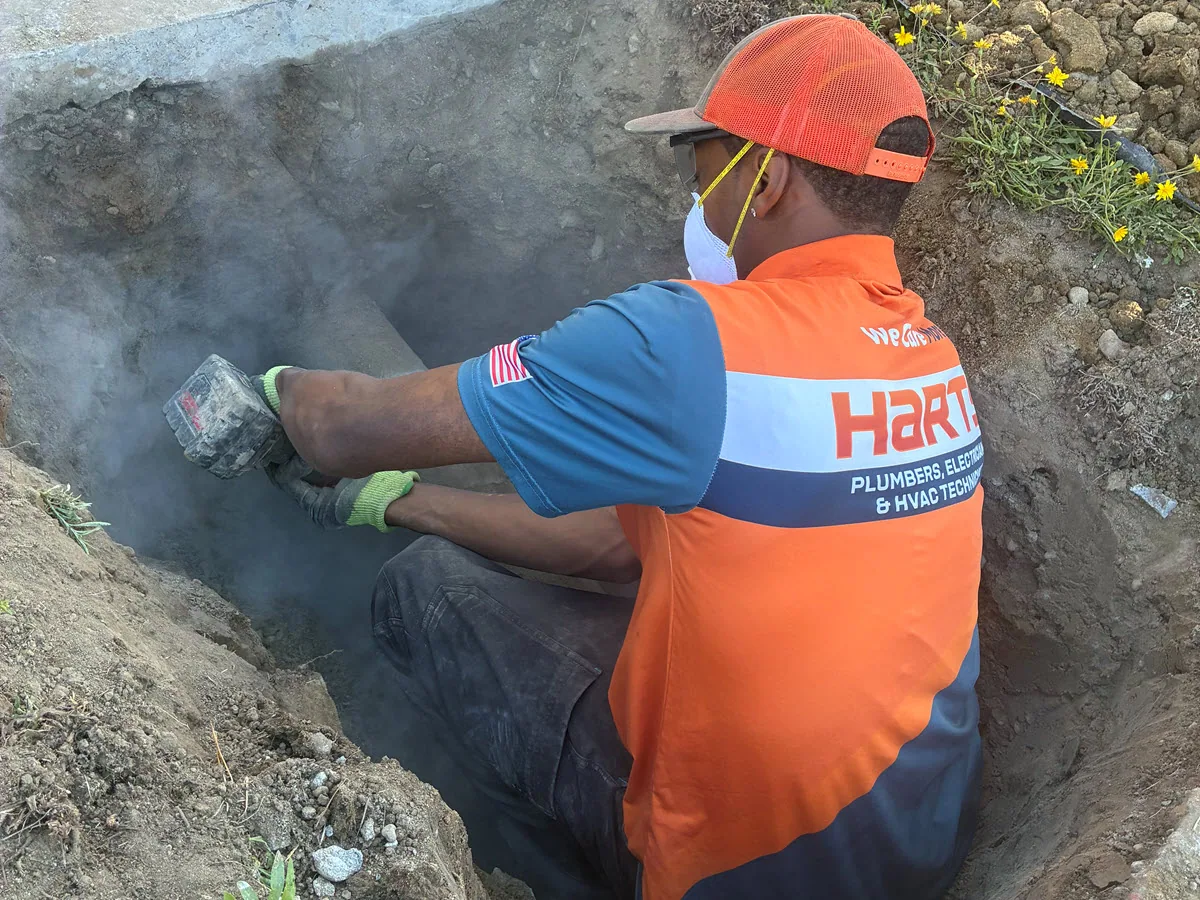 Harts technician working in a sewer line access area