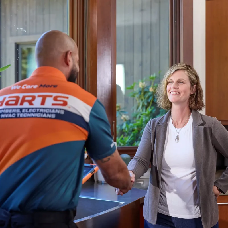 Harts technician greeting a homeowner during an in-home service visit